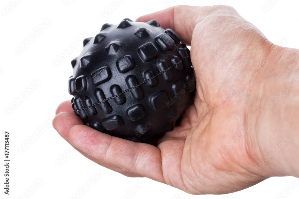 Hand holding a ball with spikes for myofascial massage. On white background. Hand holding a ball with spikes for myofascial massage. On white background.