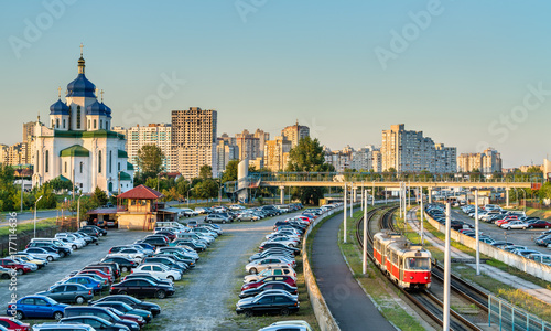 Cathedral of the Holy Trinity and a light rail tram in Troieshchyna - Kiev, Ukraine photo