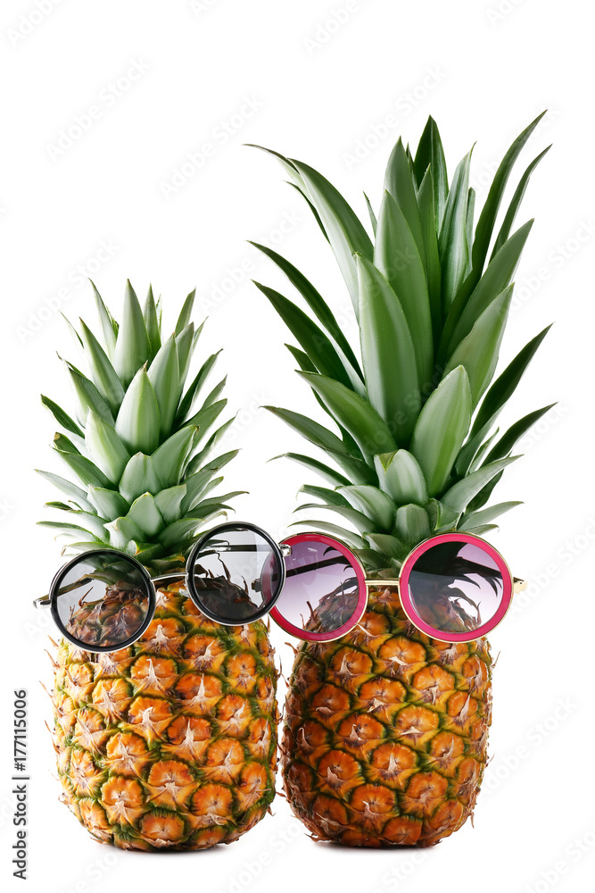 Fototapeta premium Ripe pineapple with sunglasses isolated on a white background