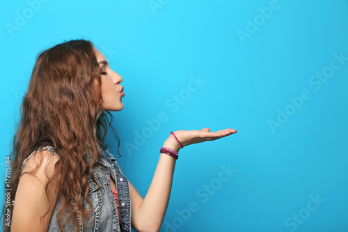 Portrait of young woman on blue background