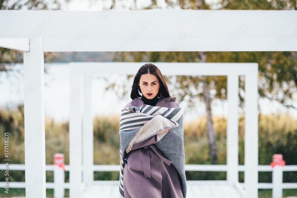 Outdoor beauty portrait woman in autumn on the beach Outdoor beauty portrait woman in autumn on the beach
