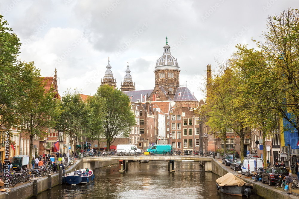 Amsterdam canal and Basilica of St. Nicholas  in the Old Centre district