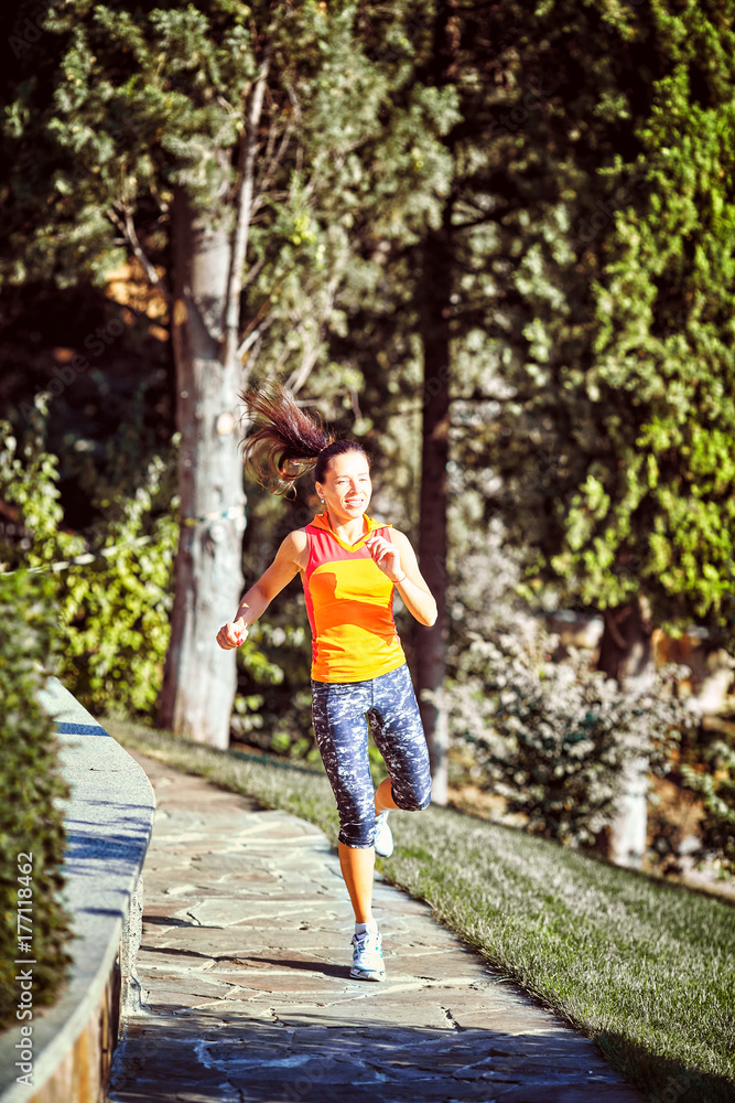 Fototapeta premium woman running around in the park in the morning
