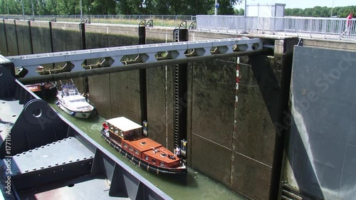 LOCK COMPLEX MAASBRACHT: Lock gate open, low lying recreational vessels move out. The Maasbracht lock overcomes a height of 11.85 meters.  THE NETHERLANDS - AUGUST 2015 photo