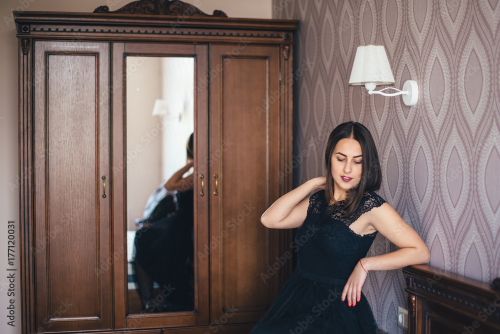 Young pretty girl posing in a beautiful room with wooden furniture Young pretty girl posing in a beautiful room with wooden furniture