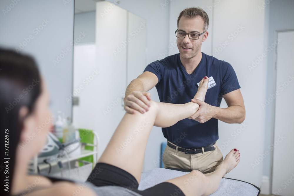 Woman receiving treatment from physio Woman receiving treatment from physio