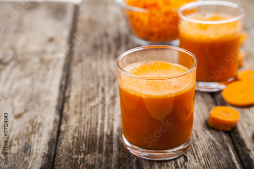 Carrot juice on a wooden table