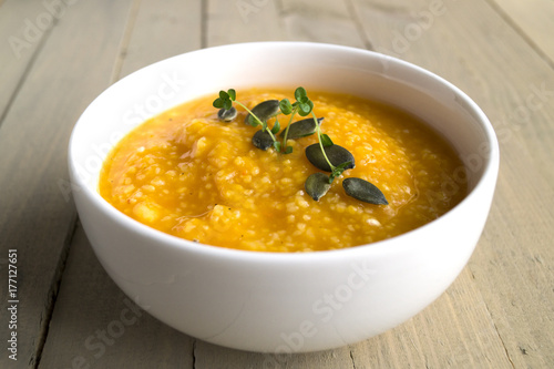 Vegetarian pumpkin soup on a wooden table.