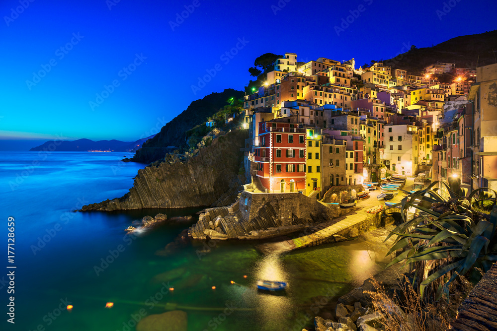 Riomaggiore village, rocks and sea at sunset. Cinque Terre, Ligury, Italy