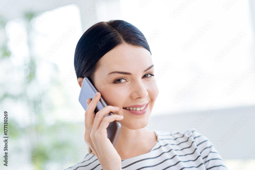Portrait of a happy delighted woman talking on the phone Portrait of a happy delighted woman talking on the phone