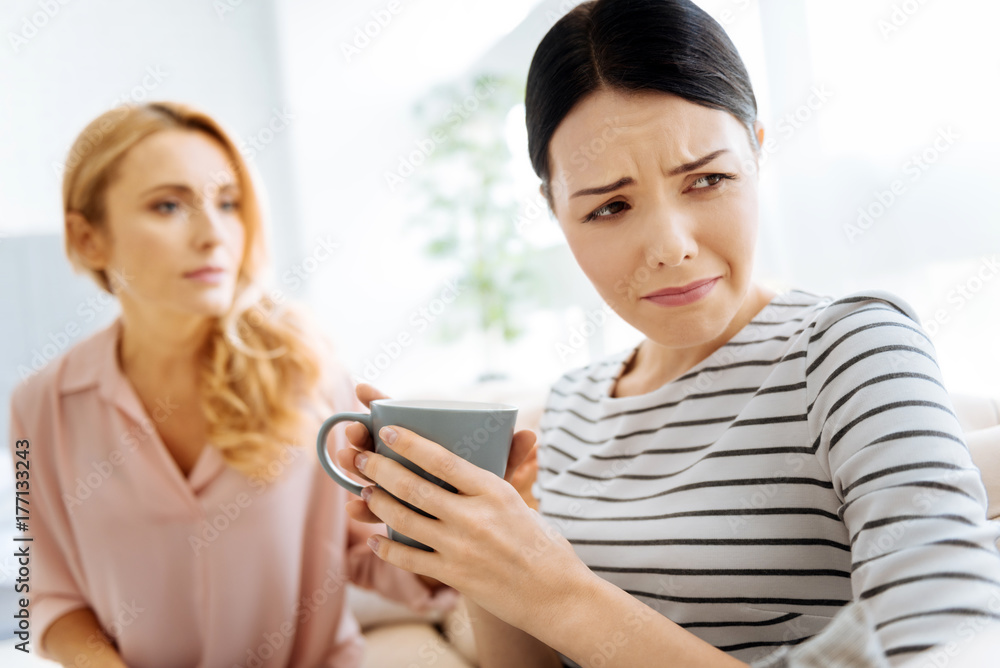 Moody upset woman drinking tea Moody upset woman drinking tea