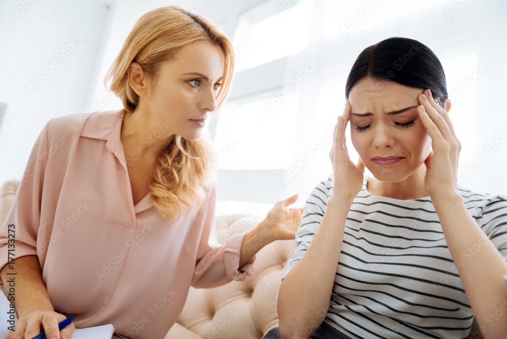 Sad cheerless woman suffering from pain Sad cheerless woman suffering from pain