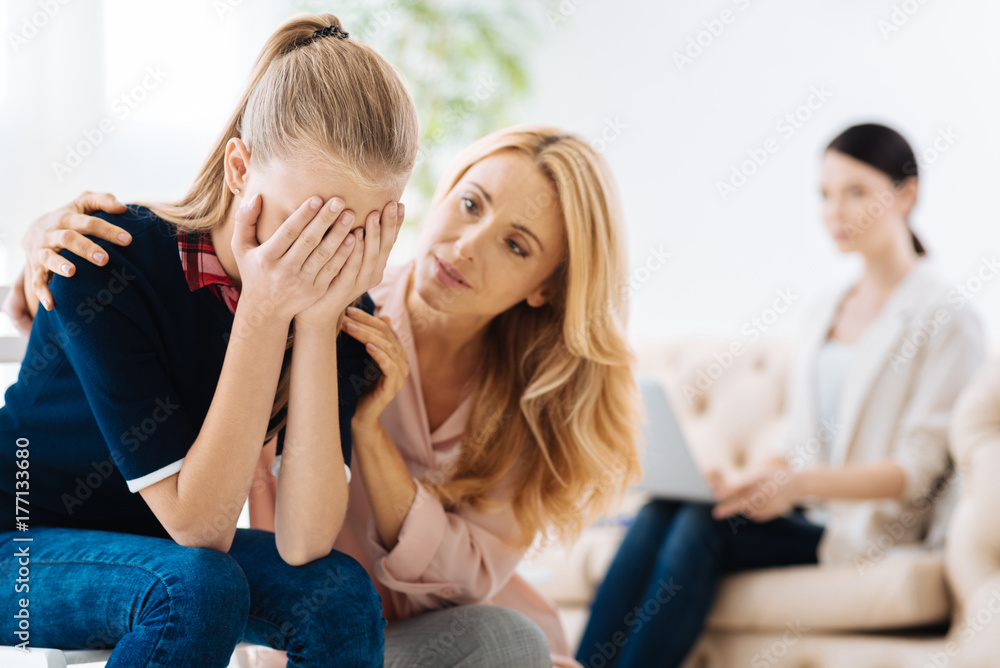 Beautiful adult woman consoling her daughter Beautiful adult woman consoling her daughter