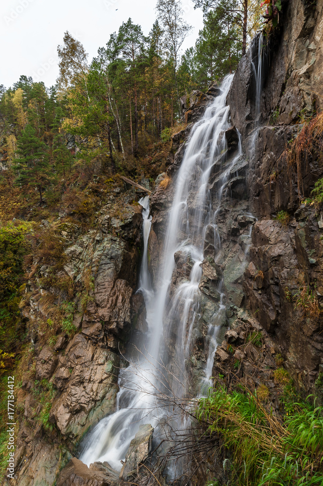 great cascading waterfall in a mountainous area