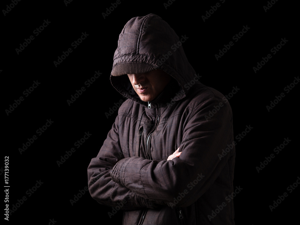 Lonely, depressed and fragile man hiding face, arms crossed and standing in the darkness. Low key, black background. Concept for loneliness, depression, sadness and mental health issues Lonely, depressed and fragile man hiding face, arms crossed and standing in the darkness. Low key, black background. Concept for loneliness, depression, sadness and mental health issues