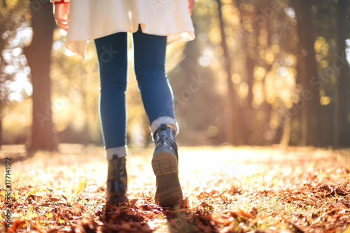 Girl walking in an autumnal park