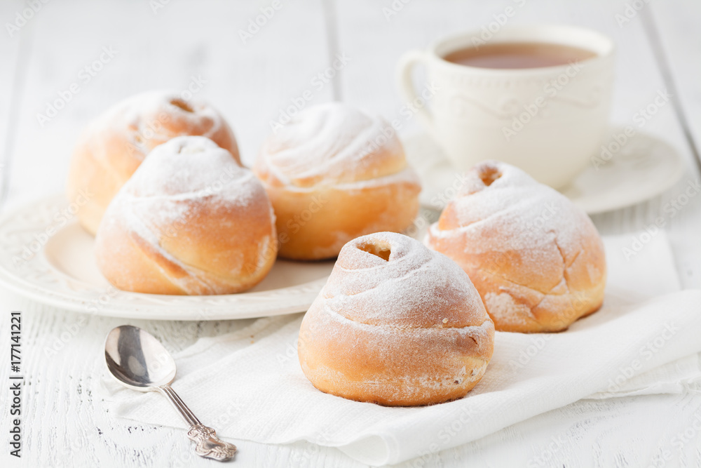 a dish of choux cream with a cup of tea or coffee for an afternoon break. a dish of choux cream with a cup of tea or coffee for an afternoon break.