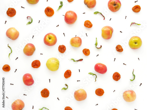Pattern of red apples and dried dried apricots. The concept of a healthy diet. Composition of fruits on a white background. Top view, flat lay.