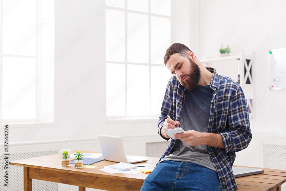Busy young businessman talk on phone in office Busy young businessman talk on phone in office