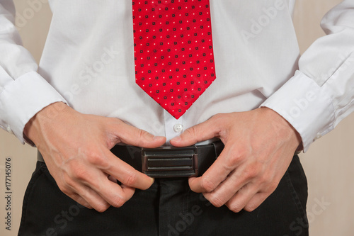 Businessman held Buckle to look good as smart man concept.