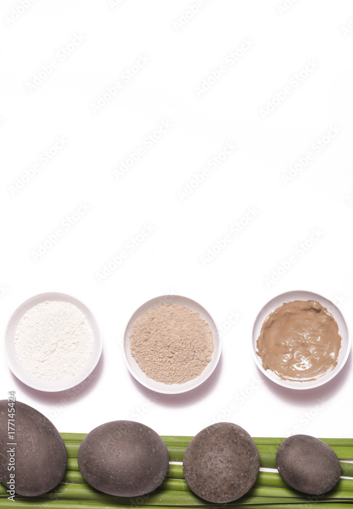 White and green cosmetic clay beside zen stones White and green cosmetic clay beside zen stones