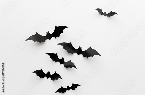 black paper bats over white background