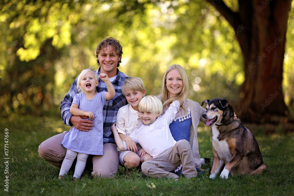 Portrait of Happy Family of Five Caucasian People and Their Pet Dog Outside