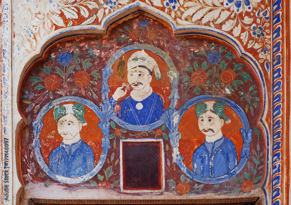 Naive fresco with three indian businessmen on background of historical wall of India