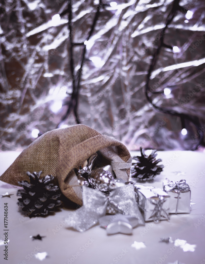 Obraz premium Beautiful silver Christmas decorations spilling out of a hessian sack