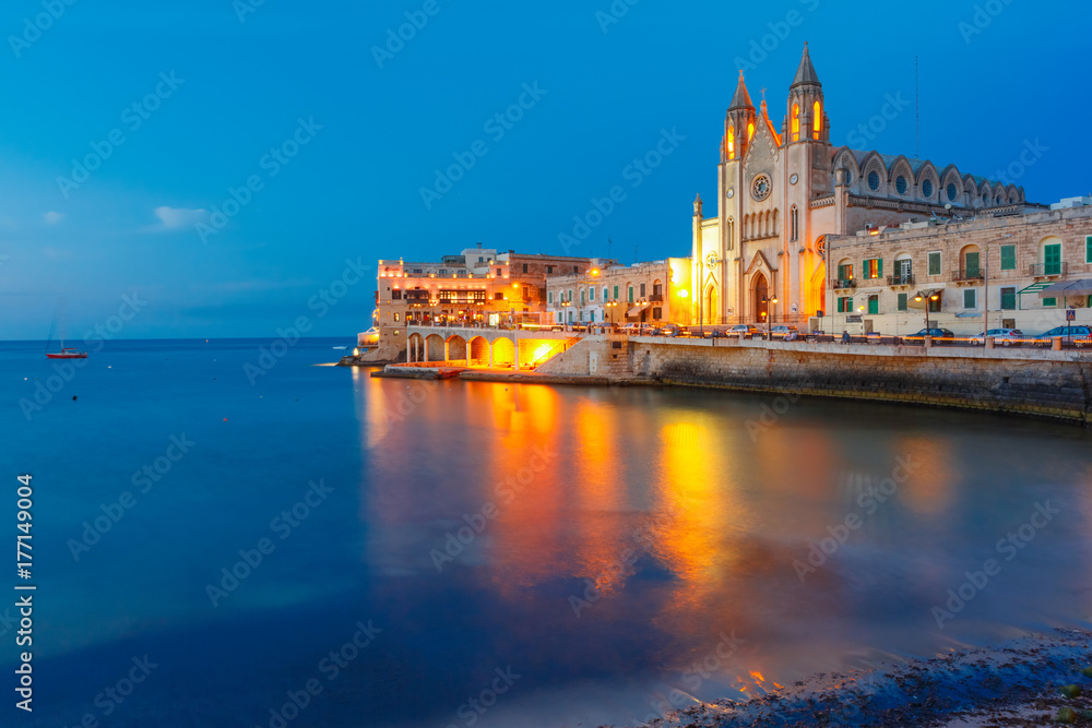 Naklejka premium Balluta Bay and Neo-Gothic Church of Our Lady of Mount Carmel, Balluta parish church, during evening blue hour, Saint Julien, Malta