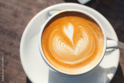 Cup of coffee latte, with heart shape.