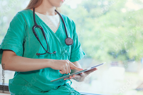 Doctor with tablet.