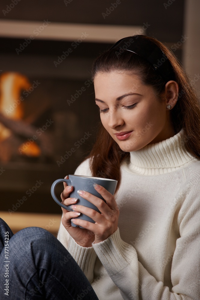 Woman sitting at fireplace Woman sitting at fireplace