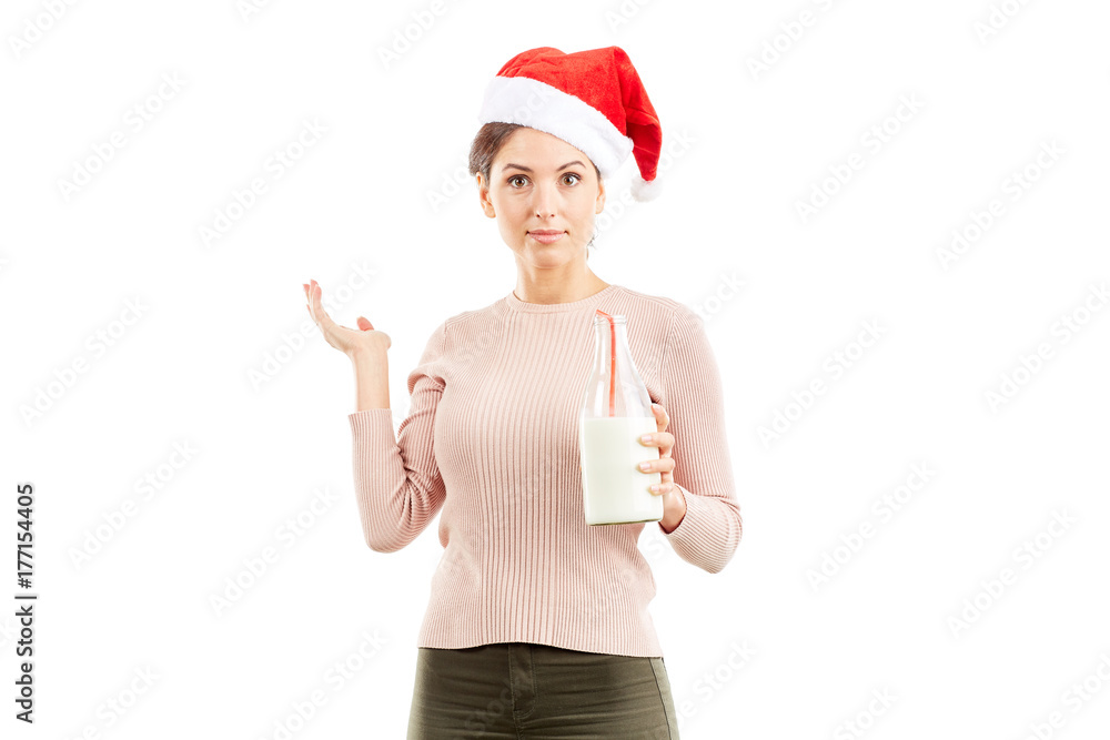 Portrait of woman in Santa hat holding bottle of milk on white background Portrait of woman in Santa hat holding bottle of milk on white background