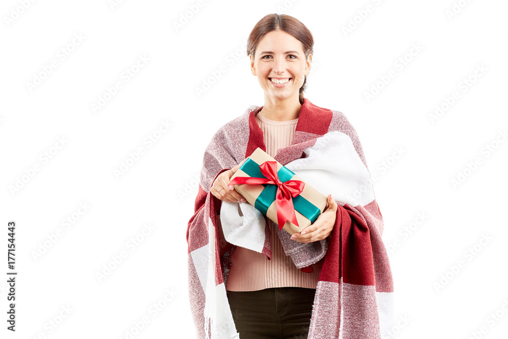 Portrait of woman wrapped in blanket holding Christmas gift Portrait of woman wrapped in blanket holding Christmas gift