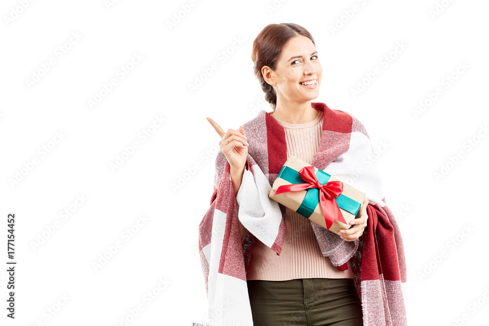Portrait of woman wrapped in blanket holding Christmas gift Portrait of woman wrapped in blanket holding Christmas gift