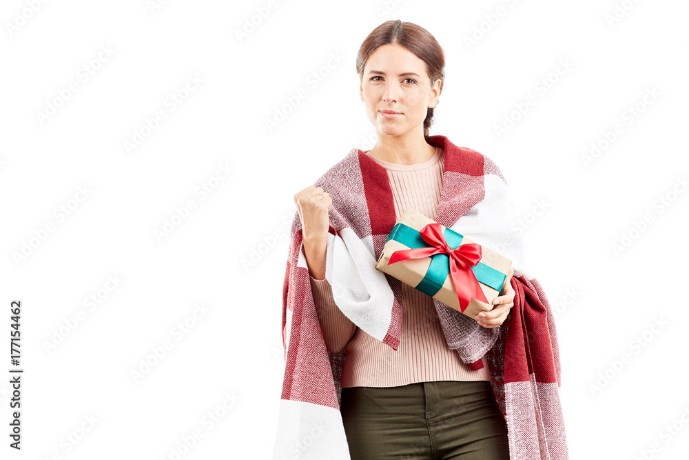 Fototapeta premium Portrait of woman wrapped in blanket holding Christmas gift