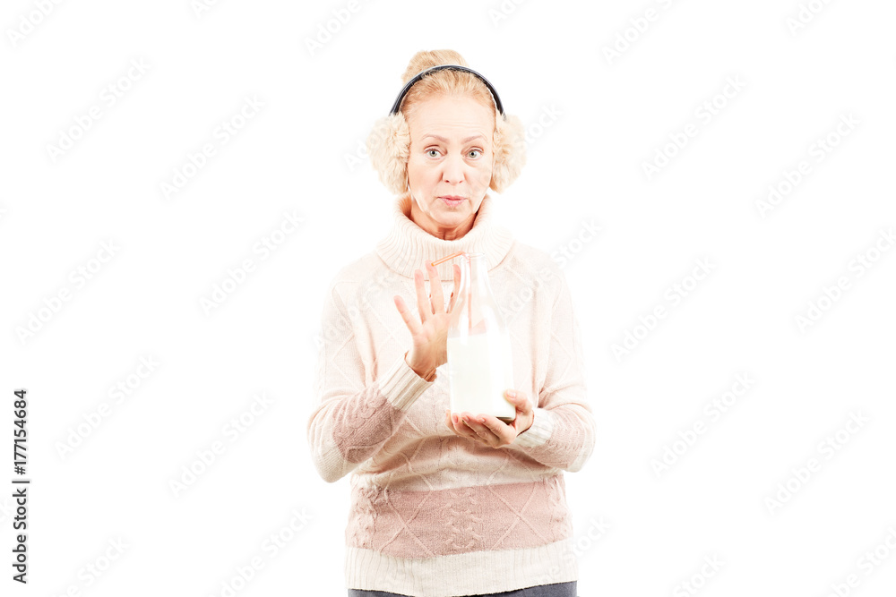 Portrait of senior woman wearing sweater and earmuffs Portrait of senior woman wearing sweater and earmuffs