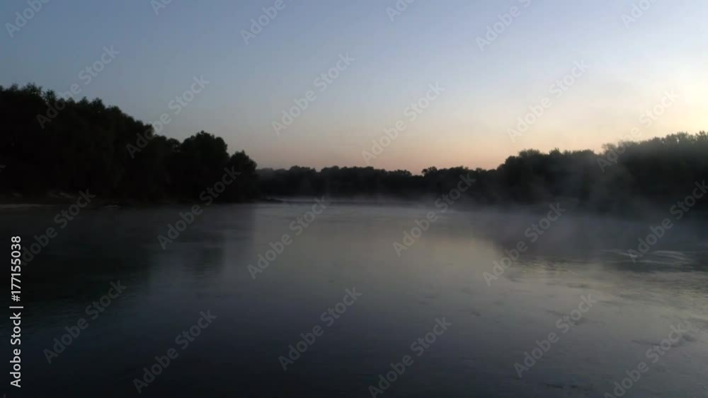 Aerial photography of the river at dawn. Rising mist from the river against the background of the rising sun Aerial photography of the river at dawn. Rising mist from the river against the background of the rising sun