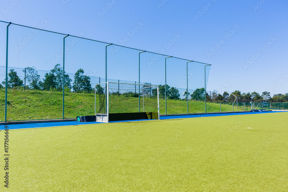 Naklejka premium Hockey Goals Field Astro Turf Blue Sky