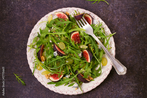 Grapes, figs, blue cheese, arugula and walnuts salad. View from above, top studio shot, horizontal