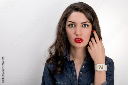 Portrait Of Beautiful Young Mediterranean And Middle Eastern Brunette Hair Girl With Perfectly Plump Red Lips Make Up And Red Nail polish. High Definition Studio Shot On White Background