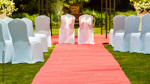 Many wedding chairs with white elegant covers photo