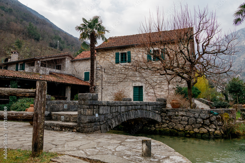 House in the mountains, snow and wooden bridge. A rustic mountain home. A bridge with wooden planks, river with snow, mountains and forest. House in the mountains, snow and wooden bridge. A rustic mountain home. A bridge with wooden planks, river with snow, mountains and forest.
