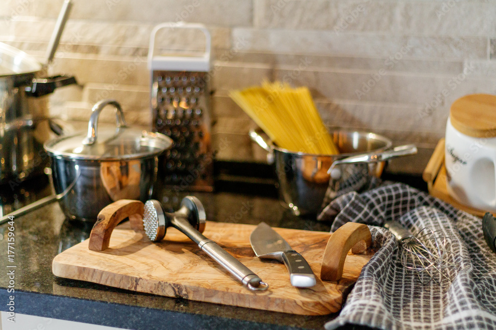 Kitchen utensils on wooden table knives spaghetti pasta