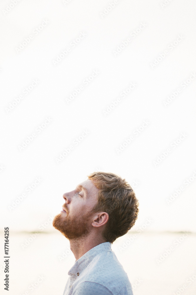 Man profile portrait by the sea at golden sunset time Man profile portrait by the sea at golden sunset time