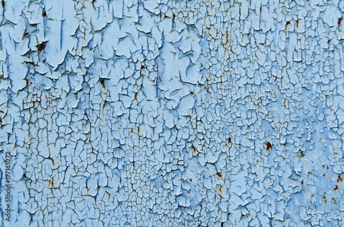 Texture of vintage rusty blue and gray iron wall background with many layers of paint and rust