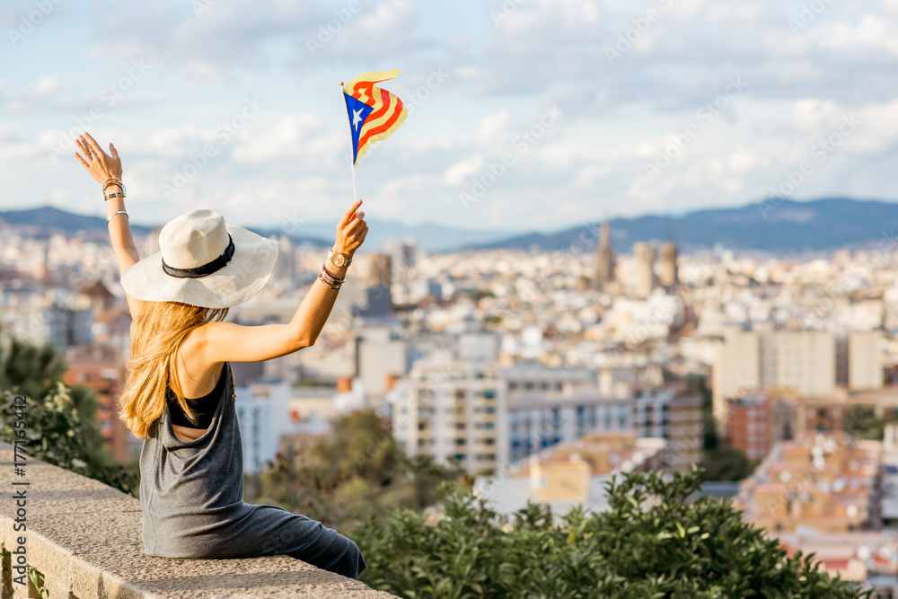 Fototapeta premium Young woman tourist in hat enjoying great cityscape view on Barcelona