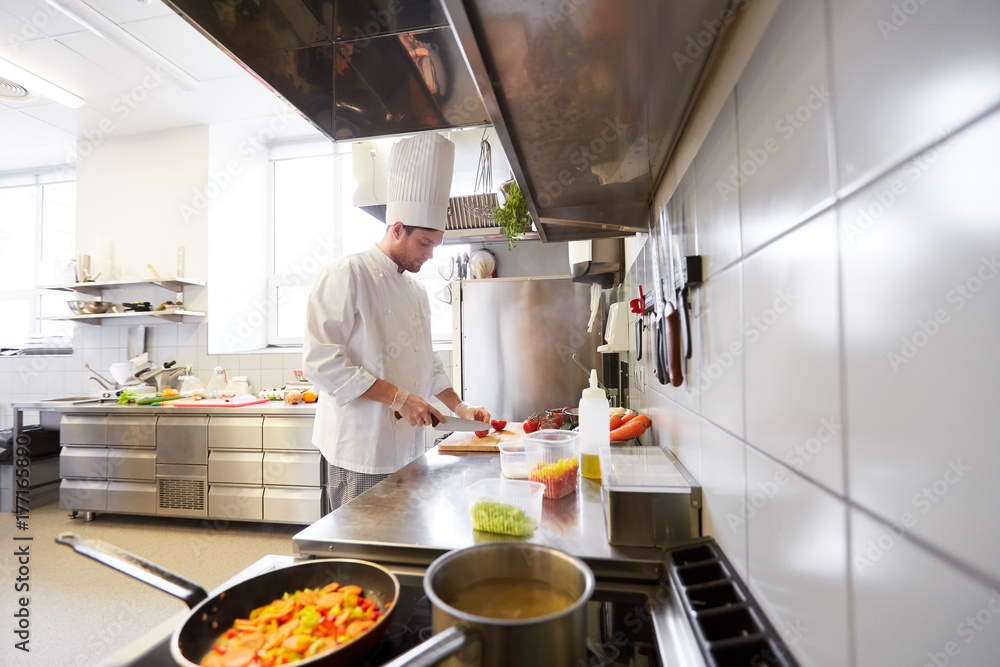 male chef cooking food at restaurant kitchen male chef cooking food at restaurant kitchen