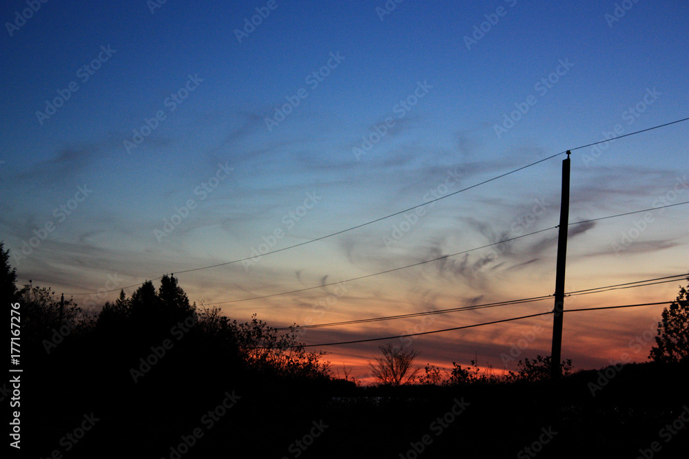 Telephone Poles sillouetted against a blue sky at sunset. Telephone Poles sillouetted against a blue sky at sunset.